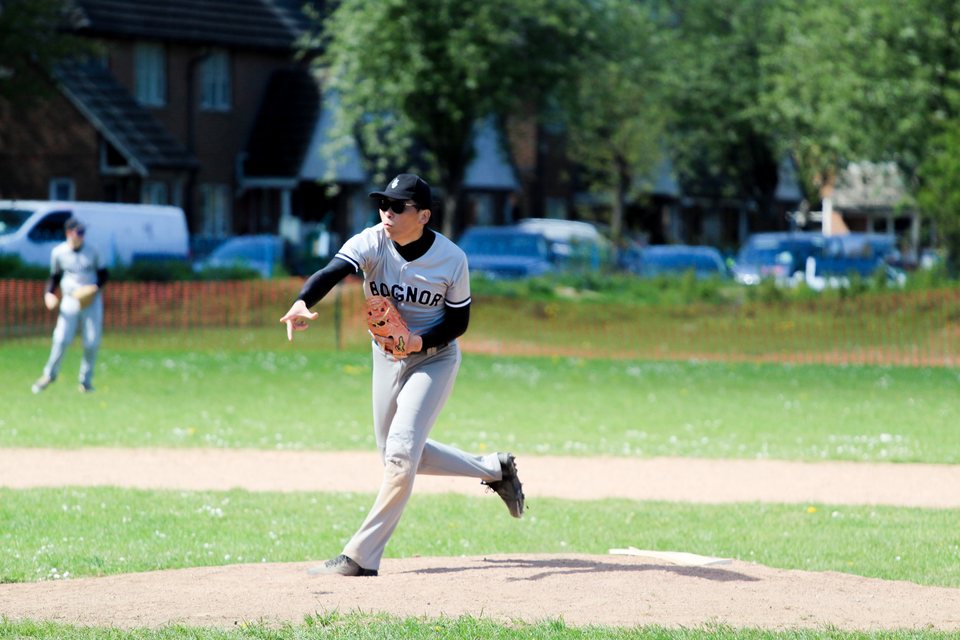 Pitcher completing a delivery from the mound